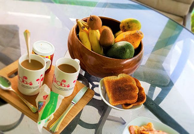 Extensive breakfast breakfast consisting of fruit coffee toast